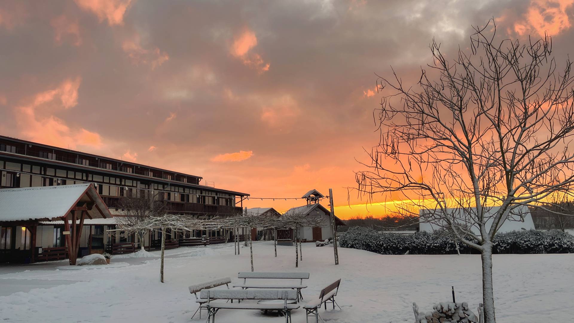 Verschneiter Grillplatz auf dem Golchener Hof im Winter bei Sonnenuntergang